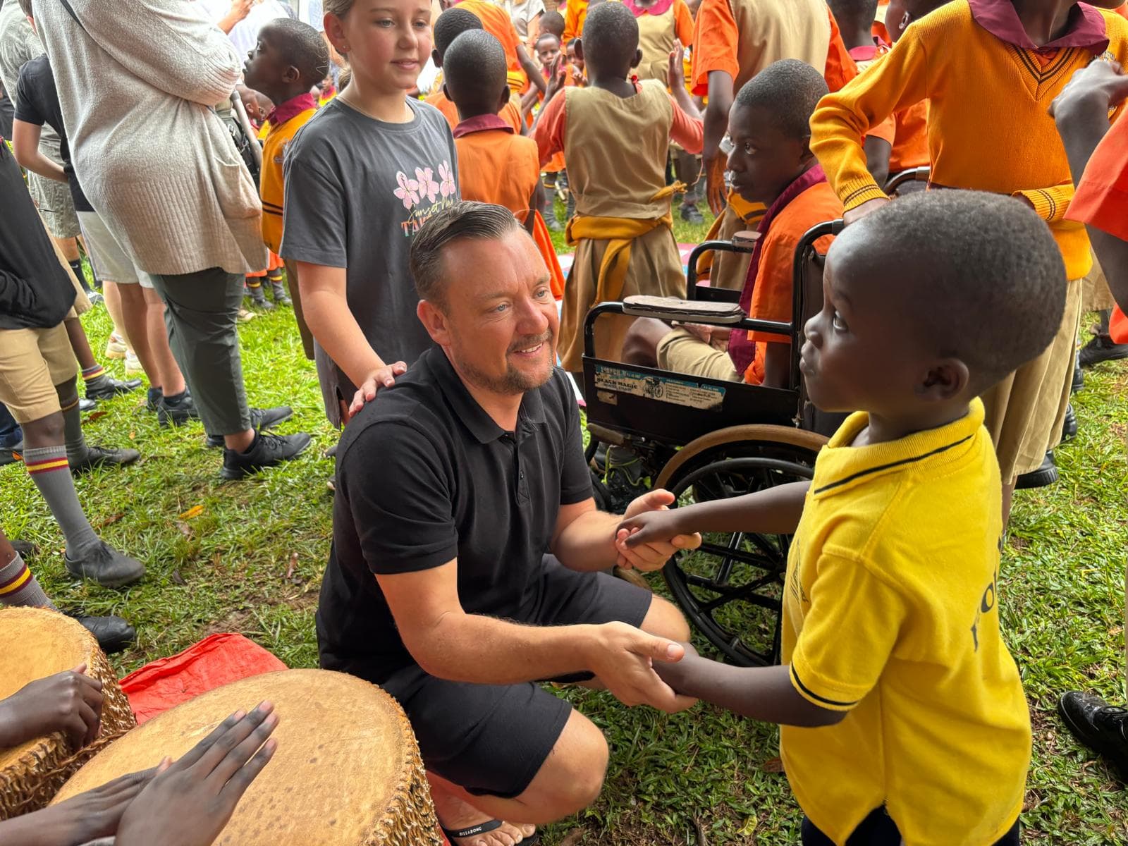 Chris White doing charity work with children in Africa
