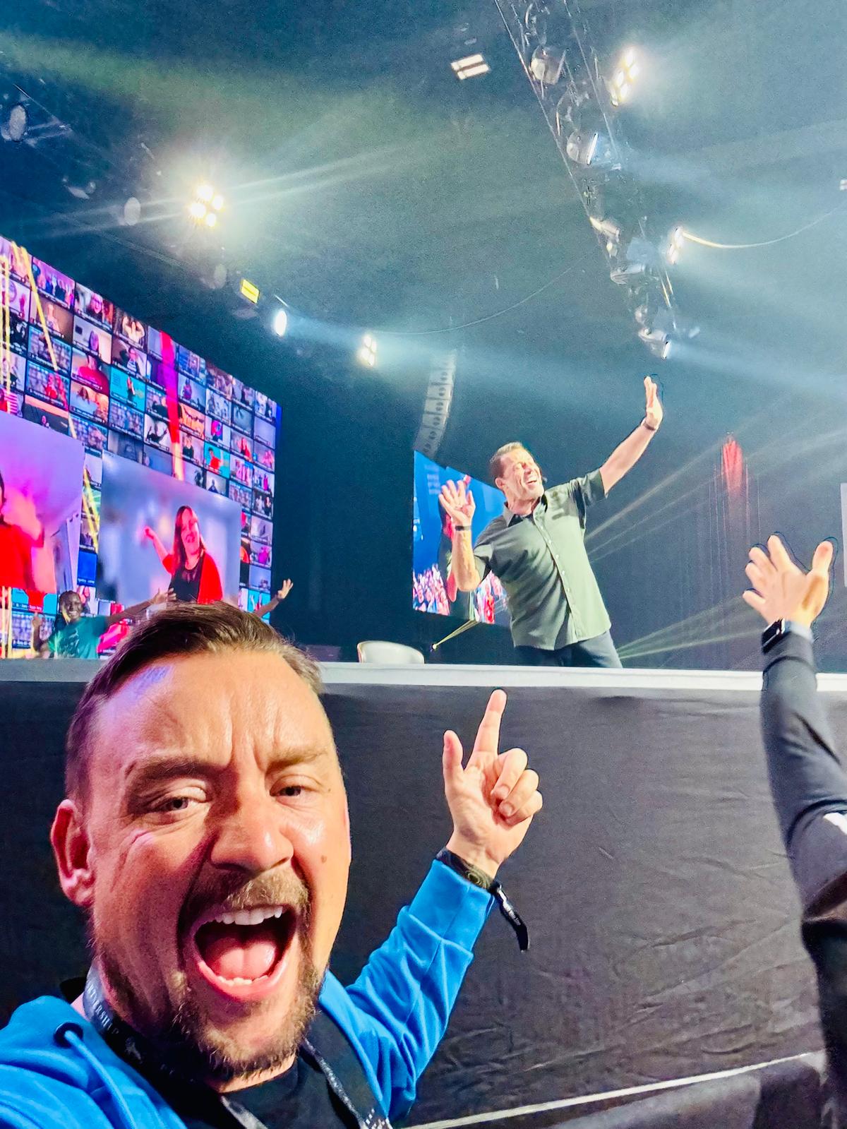 Chris White on stage with Tony Robbins